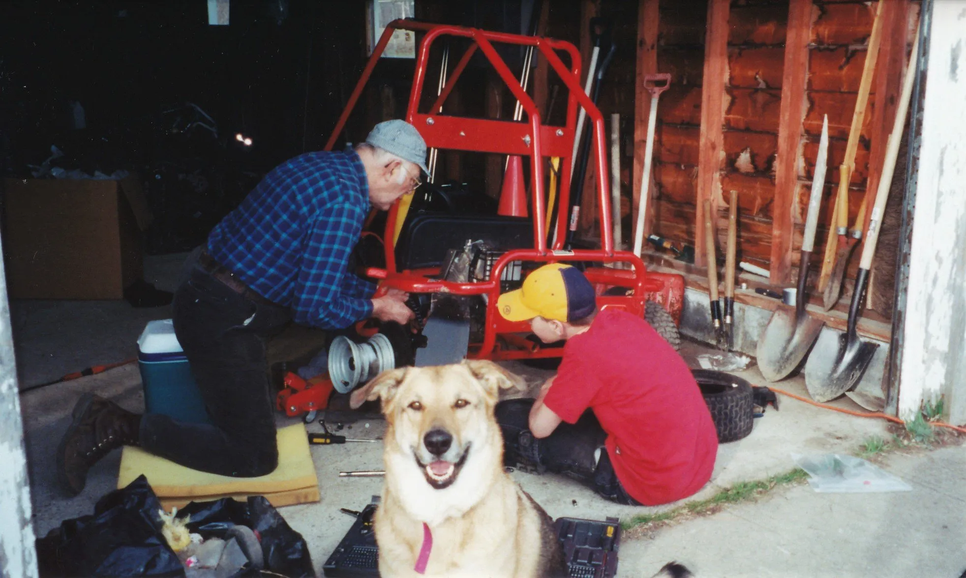 Working on a go-kart with Cookie the dog